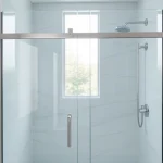 Showcasing sleek sliding shower doors with elegant glass panels in a modern bathroom.