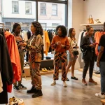 Sunwin fashion shoppers enjoying diverse clothing styles in a vibrant store.