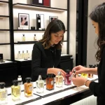 Customers exploring Razaouge 540 and premium perfumes in an elegant fragrance boutique
